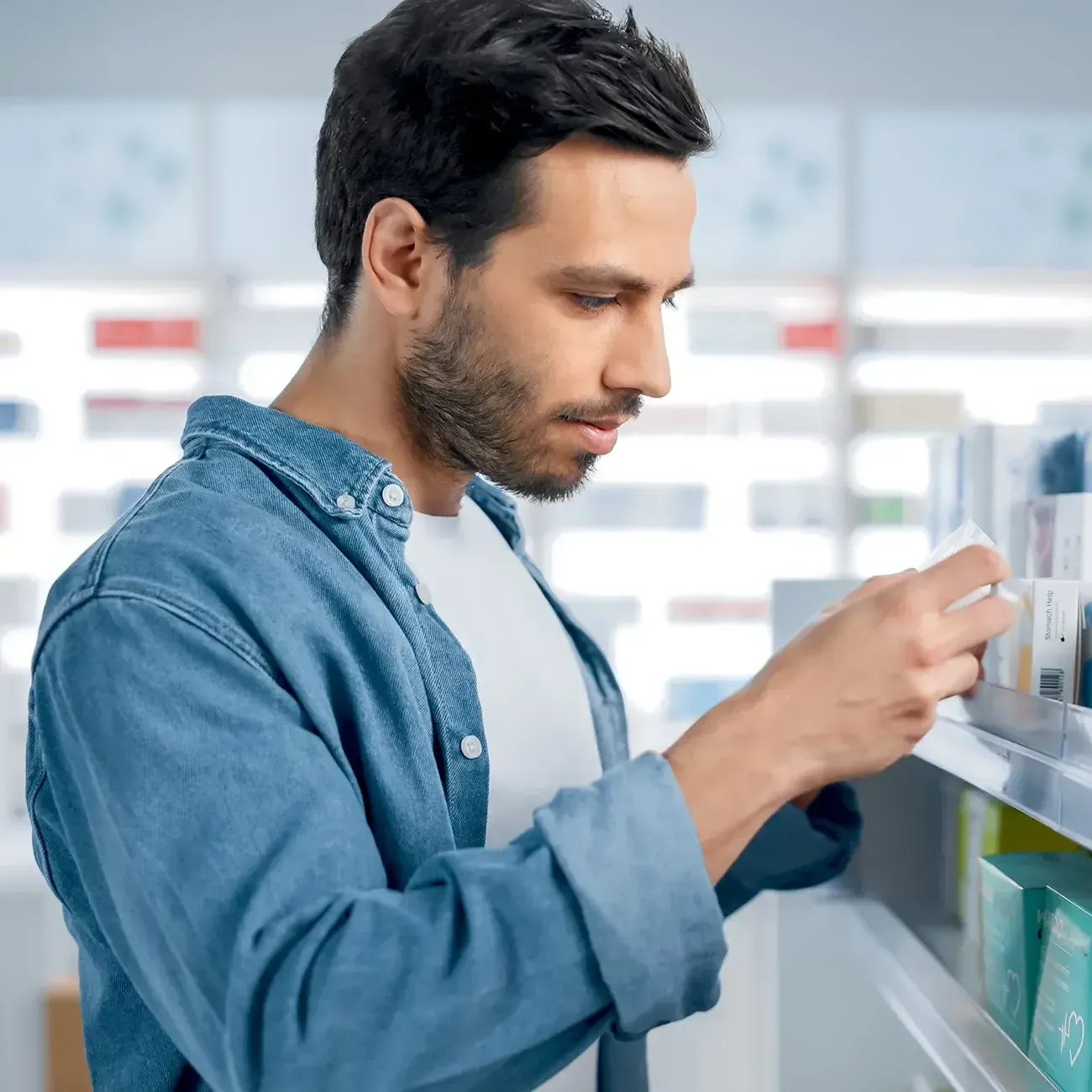 Man selecting sleep aids at a pharmacy