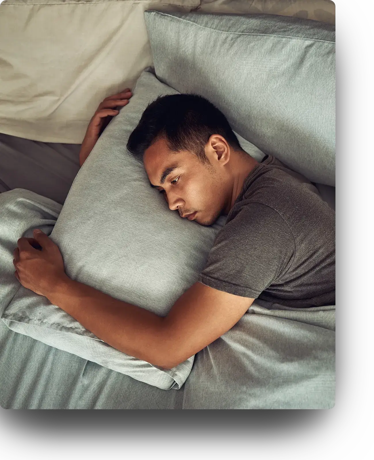 Man with insomnia struggling to fall asleep